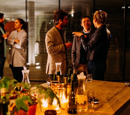 five person standing while talking each other